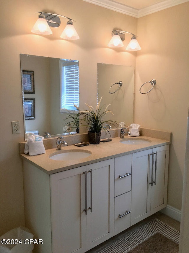 bathroom with crown molding and dual vanity