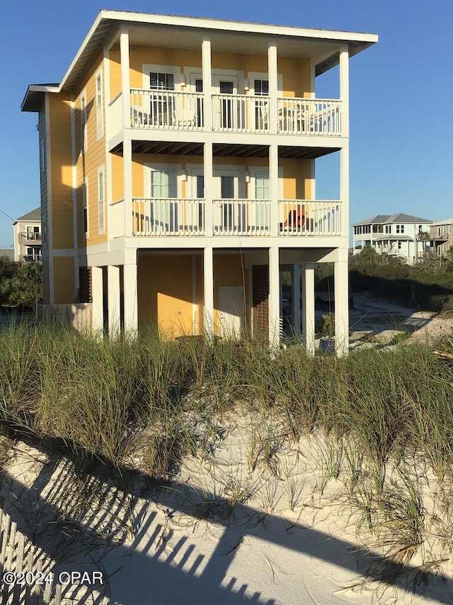 rear view of property with a balcony