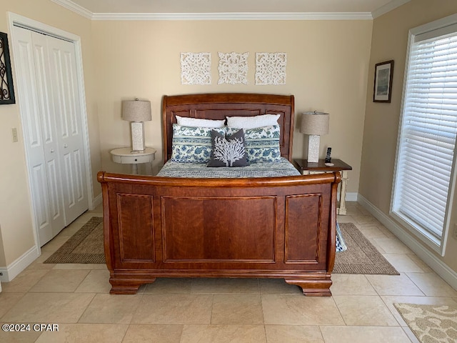 tiled bedroom with a closet and ornamental molding