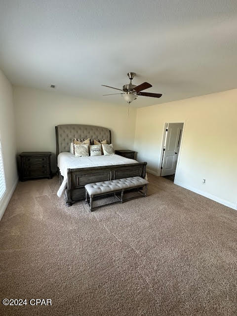 bedroom featuring ceiling fan and carpet