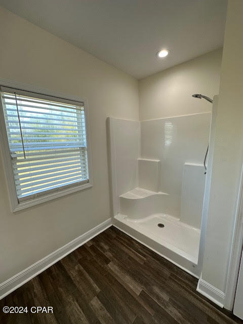 bathroom with hardwood / wood-style floors and walk in shower