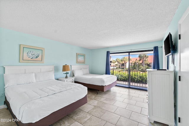 bedroom featuring light tile flooring, access to outside, and a textured ceiling