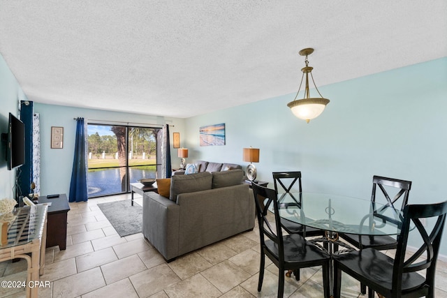 tiled living room featuring a textured ceiling