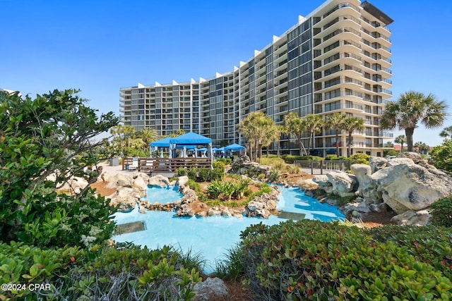 view of building exterior with a community pool