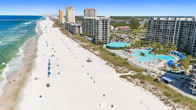 aerial view with a water view and a beach view