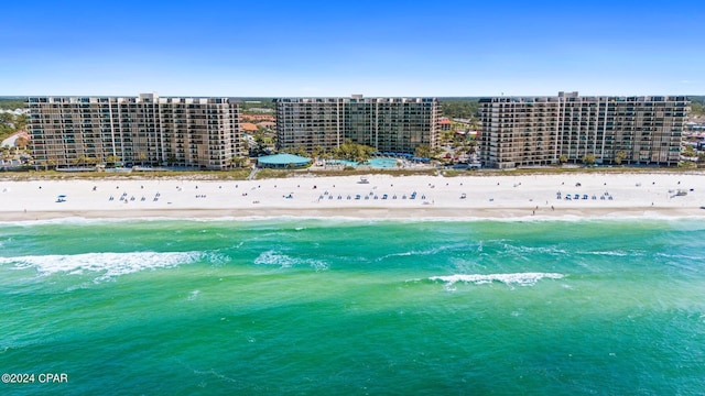 bird's eye view featuring a water view and a view of the beach