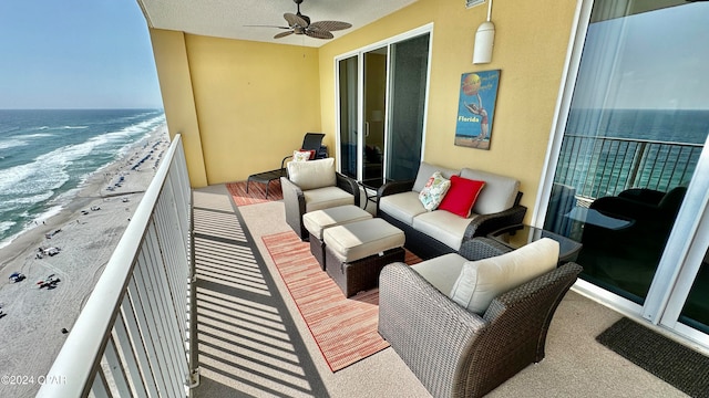 balcony featuring a water view, ceiling fan, and a view of the beach