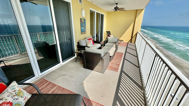 balcony featuring an outdoor living space, ceiling fan, and a water view