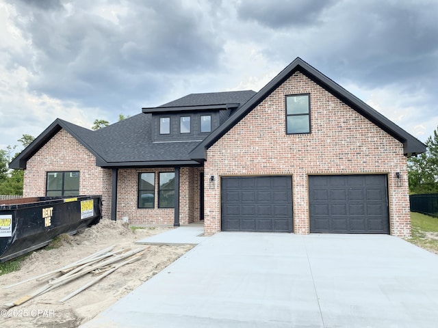 610 Shady Oaks Ln, Lynn Haven, FL 32444 - view of front of home with roof with shingles, brick siding, concrete driveway, and an attached garage