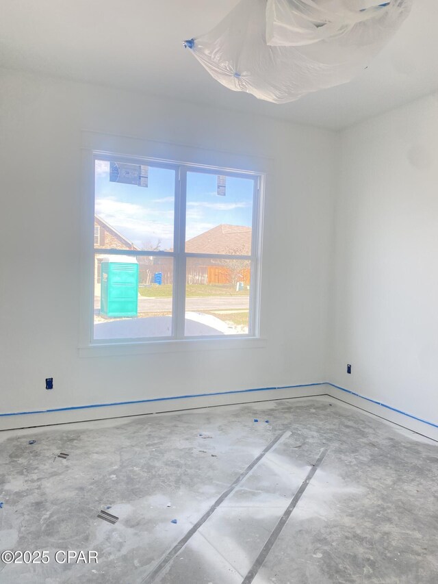 610 Shady Oaks Ln, Lynn Haven, FL 32444 - spare room with unfinished concrete floors and baseboards