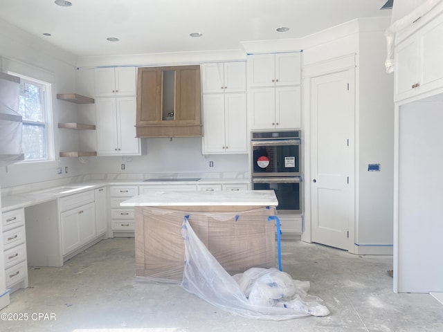 kitchen with white cabinets, black electric stovetop, open shelves, and stainless steel double oven