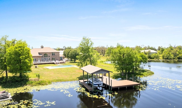 view of pool with a lawn and a water view