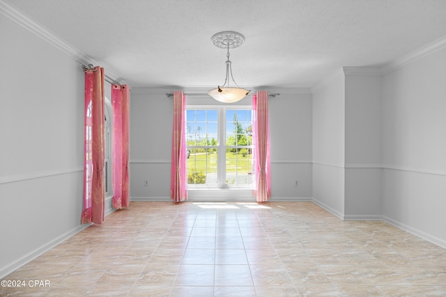 tiled spare room with a textured ceiling and crown molding