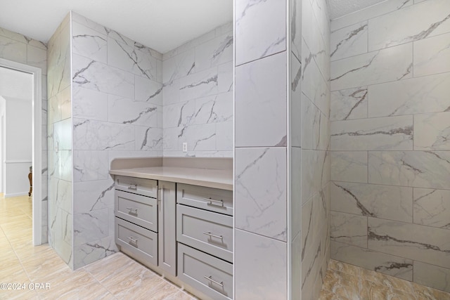 bathroom featuring tile walls, tile patterned floors, and vanity