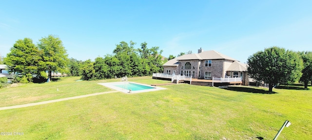 exterior space featuring a pool side deck and a yard