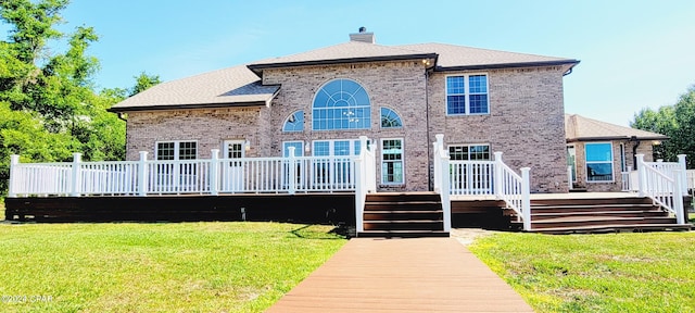 view of front of property with a front lawn and a deck