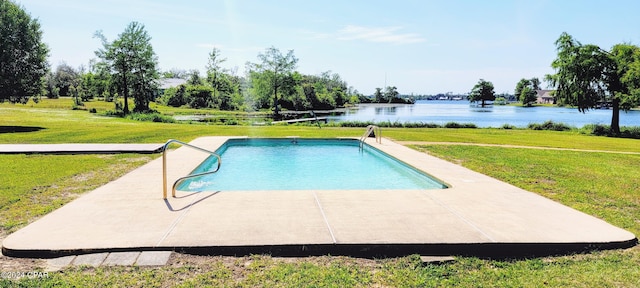 view of swimming pool featuring a yard and a water view