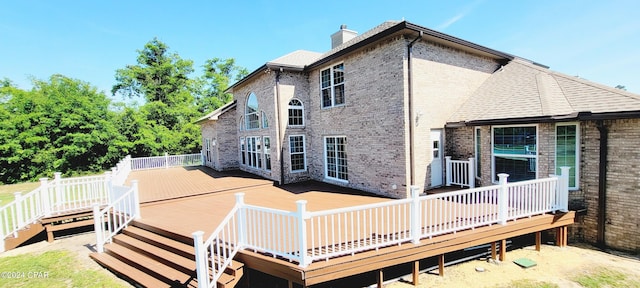 rear view of property featuring a deck