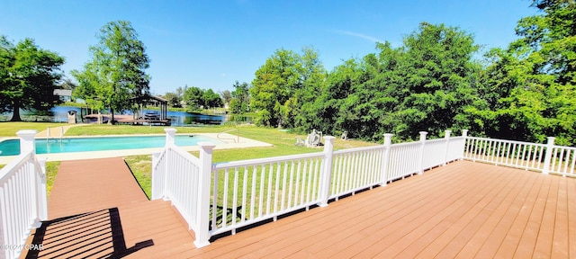 wooden terrace with a lawn and a water view