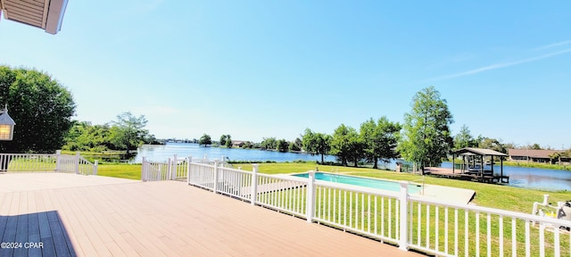 deck with a yard and a water view