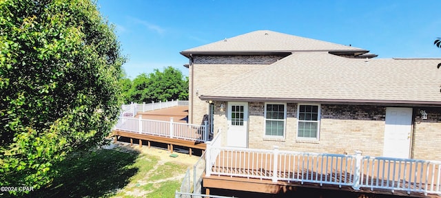 back of house featuring a deck