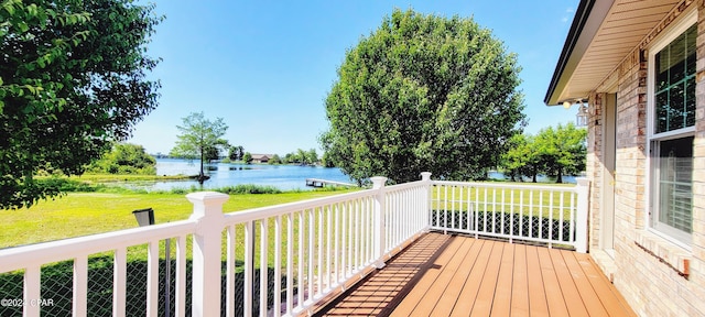 wooden deck featuring a yard and a water view