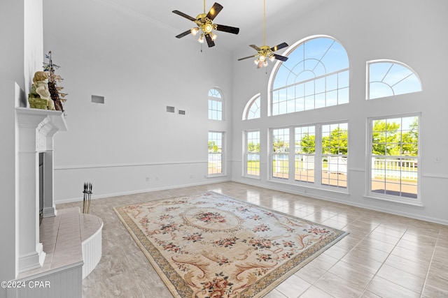 tiled living room featuring high vaulted ceiling and ceiling fan