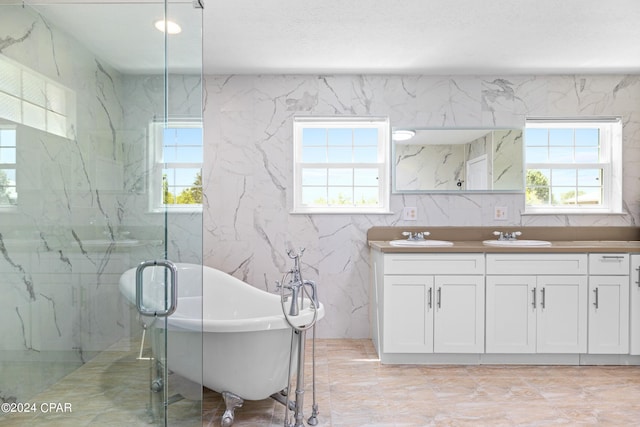 bathroom with tile walls, a healthy amount of sunlight, and tile patterned floors