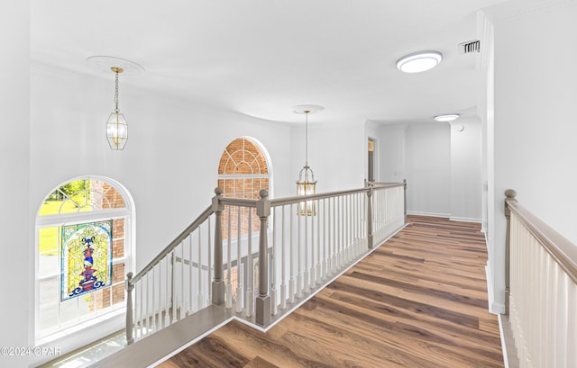 corridor featuring hardwood / wood-style floors and ornamental molding