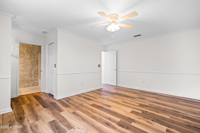 spare room with ceiling fan, crown molding, and hardwood / wood-style floors