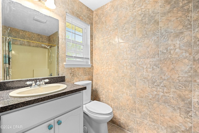 bathroom featuring tile walls, toilet, vanity, and tile patterned floors