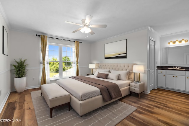 bedroom with sink, ceiling fan, crown molding, and hardwood / wood-style flooring