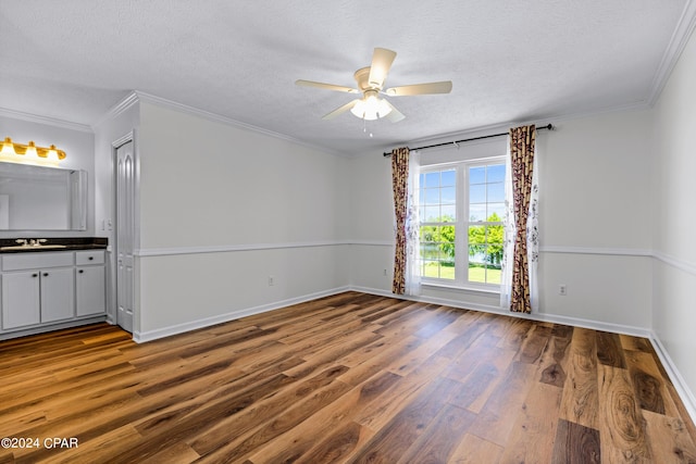 unfurnished room with hardwood / wood-style floors, crown molding, a textured ceiling, and ceiling fan