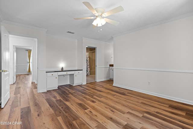 unfurnished living room featuring hardwood / wood-style floors, crown molding, and ceiling fan