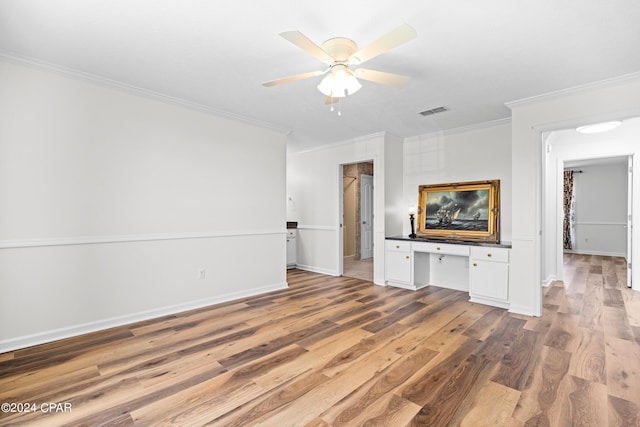 unfurnished living room with hardwood / wood-style flooring, crown molding, and ceiling fan