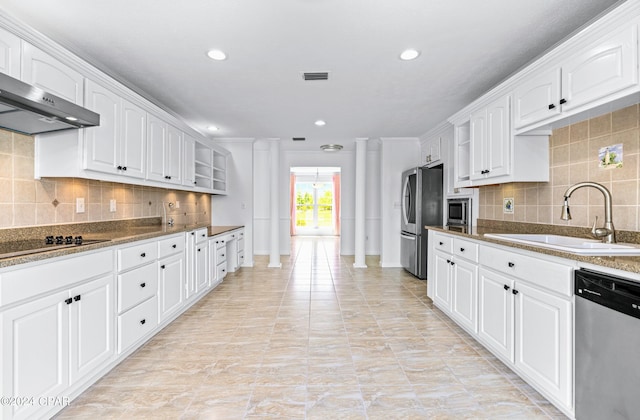 kitchen with backsplash, sink, stainless steel appliances, and white cabinets