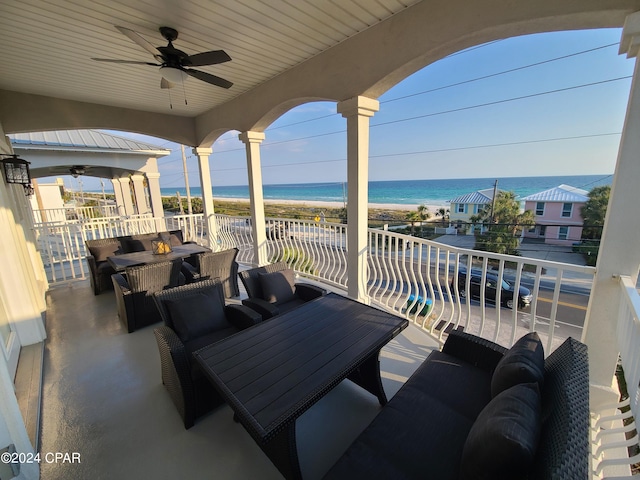 view of patio / terrace featuring a balcony, outdoor lounge area, ceiling fan, and a water view