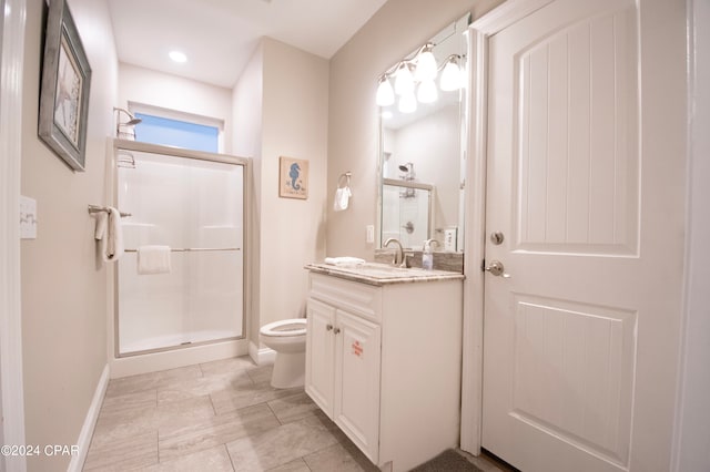 bathroom with walk in shower, vanity, tile floors, and toilet