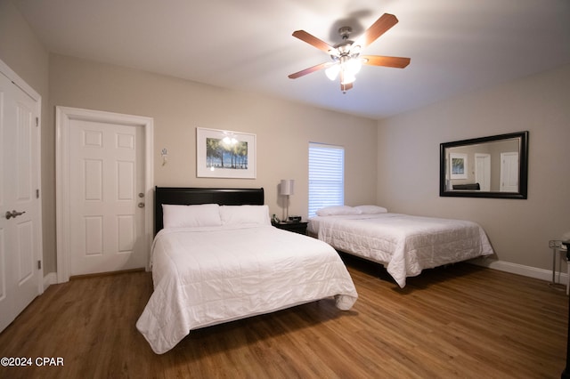 bedroom featuring dark wood-type flooring and ceiling fan