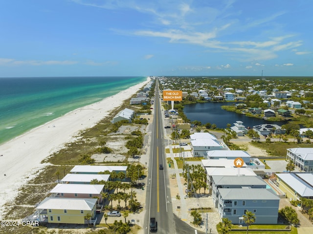 drone / aerial view with a water view and a beach view