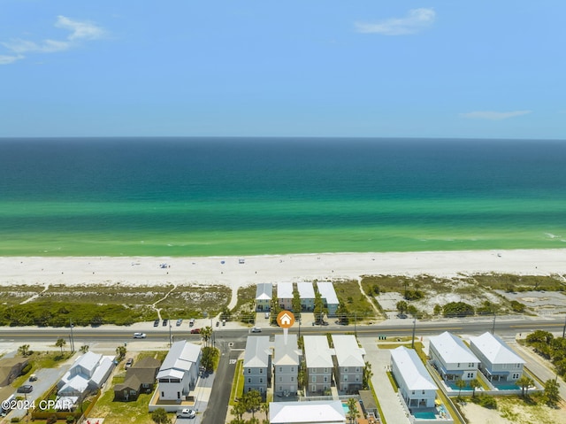 bird's eye view featuring a view of the beach and a water view