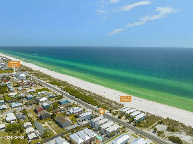 aerial view with a water view and a beach view