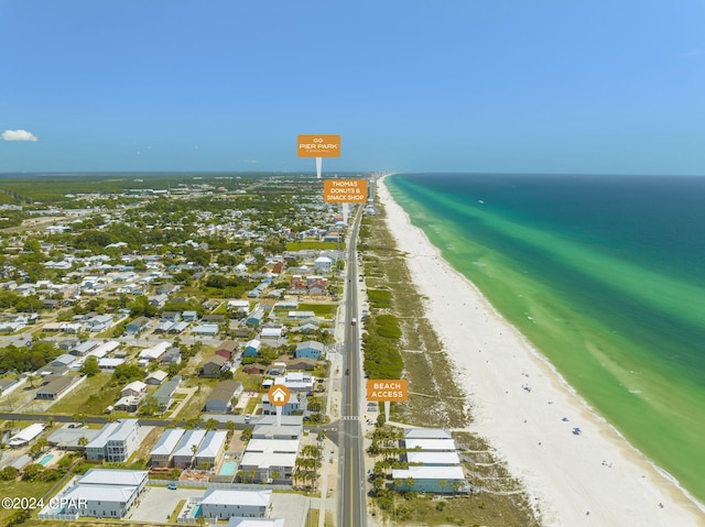 aerial view with a water view and a beach view