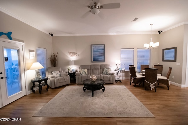 living room with ornamental molding, wood-type flooring, and ceiling fan with notable chandelier