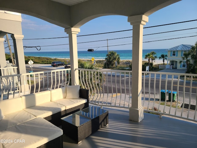 view of terrace with a balcony and a water view