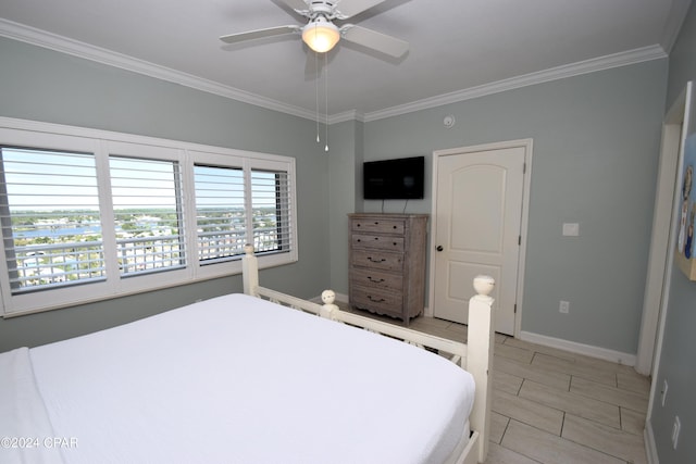 bedroom with ceiling fan and ornamental molding