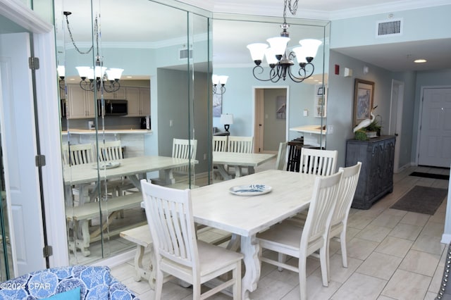 dining space with light tile patterned floors, crown molding, and an inviting chandelier