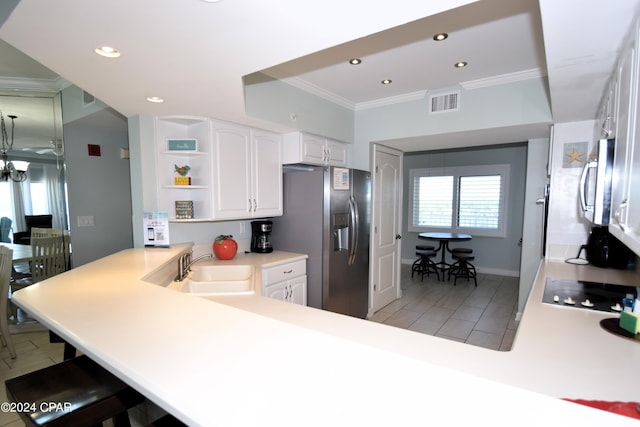 kitchen featuring kitchen peninsula, white cabinetry, sink, and stainless steel appliances