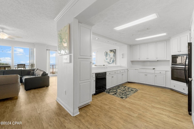 kitchen featuring white cabinets, light hardwood / wood-style floors, ceiling fan, and black appliances