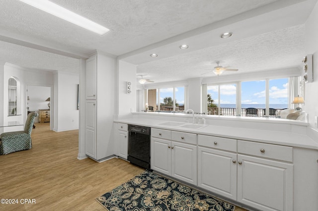 kitchen featuring ceiling fan, light hardwood / wood-style floors, black dishwasher, white cabinetry, and sink